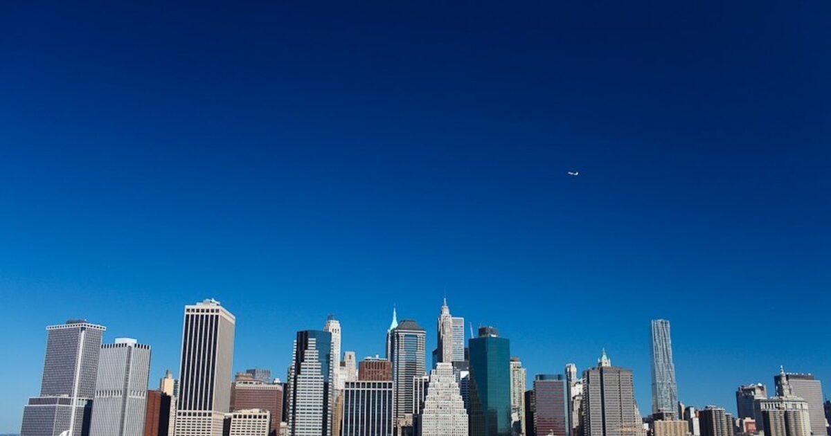 The Lower Manhattan skyline seen from across the water, many towers as one view